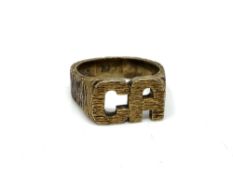 A heavy silver gilt textured ring initialled 'CA'.
