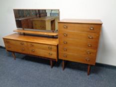 A mid 20th century teak four drawer dressing chest with matching five drawer chest (missing leg)