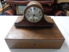 An Edwardian oak cutlery canteen together with an oak cased mantel clock with silvered dial