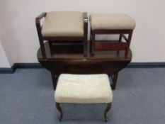 A continental flap sided coffee table together with three footstools