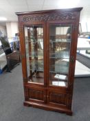 A carved Old Charm double door leaded glass display cabinet fitted cupboards beneath