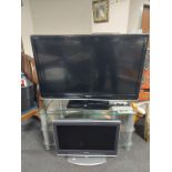 A Toshiba Regza 46'' LCD TV with remote on three tier glass stand,