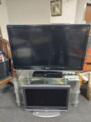 A Toshiba Regza 46'' LCD TV with remote on three tier glass stand,