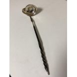 A silver toddy ladle inset with a coin