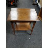 An Edwardian oak two tier occasional table