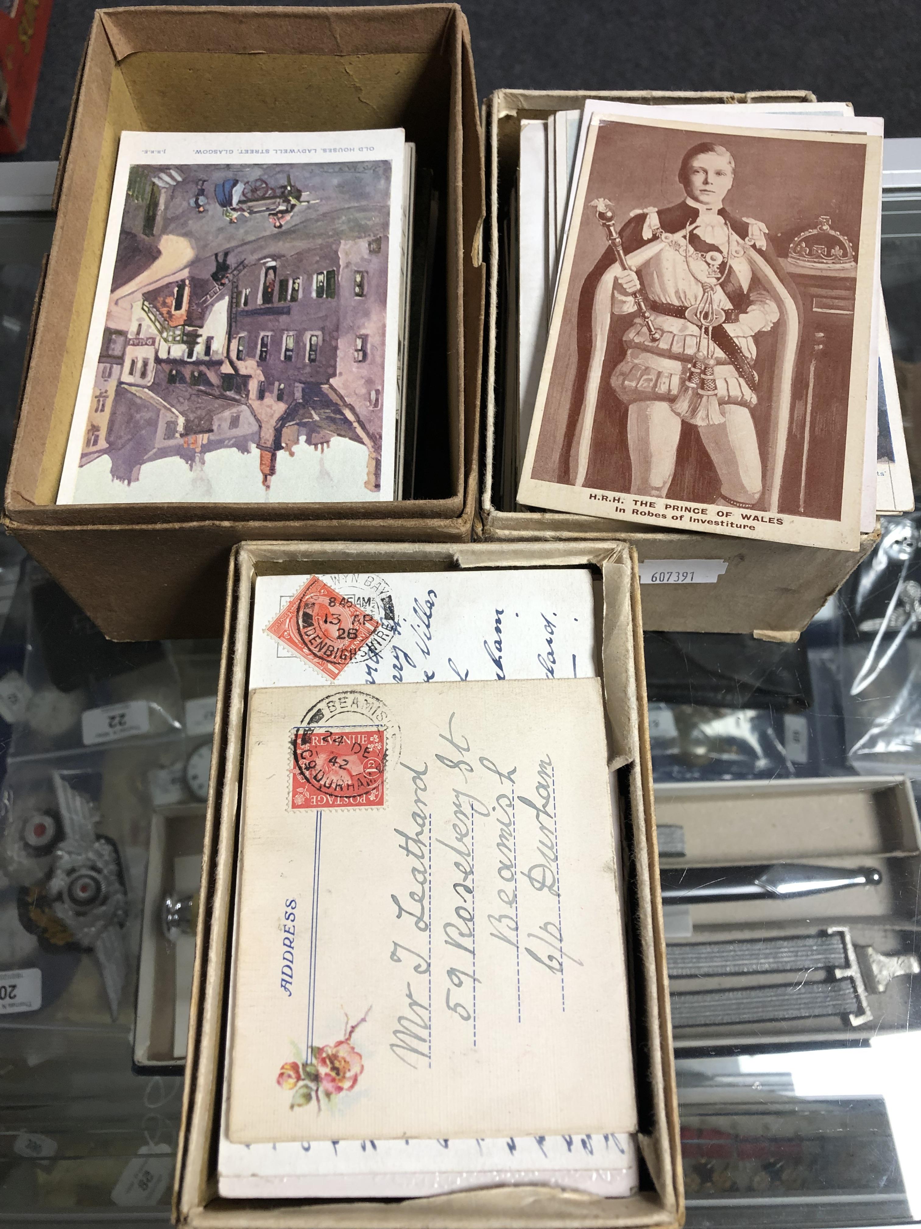 Three boxes containing a collection of antiquarian and later postcards