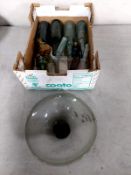 A box containing a quantity of vintage bottles and an Italian shaped glass dish