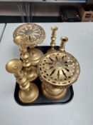 A tray containing three pairs of brass candlesticks together with a pair of brass pedestals