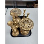 A tray containing three pairs of brass candlesticks together with a pair of brass pedestals