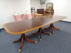 A Regency style mahogany triple pedestal dining table on brass capped feet