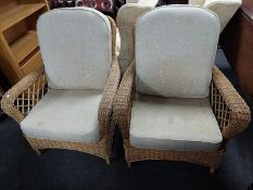 A pair of wicker conservatory armchairs
