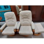 A pair of contemporary cream leather relaxer chairs together with a matching footstool