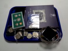 A tray containing assorted coinage to include crowns, coin collector's albums, foreign coinage,