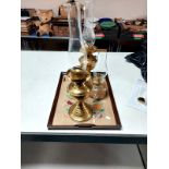 An oak twin handled serving tray together with two brass oil lamps and one further glass oil lamp