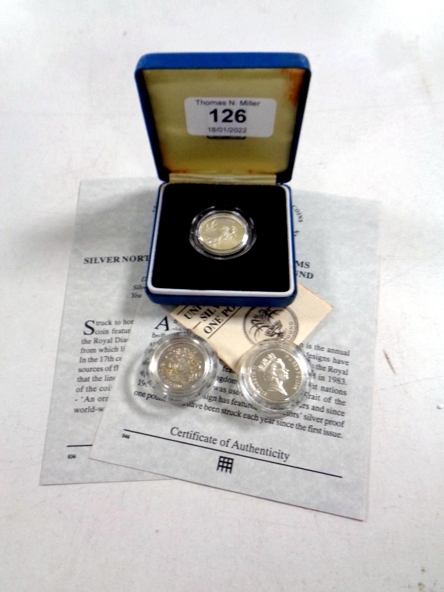 Three Royal Mint silver proof one pound coins, 1983 (cased) together with 1983 and 1986,