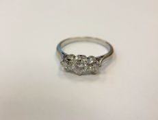 An 18ct white gold three stone diamond ring, size O. CONDITION REPORT: 2.