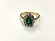 An 18ct gold emerald and diamond cluster ring, size O. CONDITION REPORT: 4.