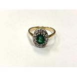 An 18ct gold emerald and diamond cluster ring, size O. CONDITION REPORT: 4.