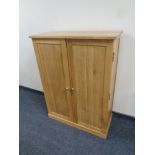 A contemporary oak double door shoe cabinet