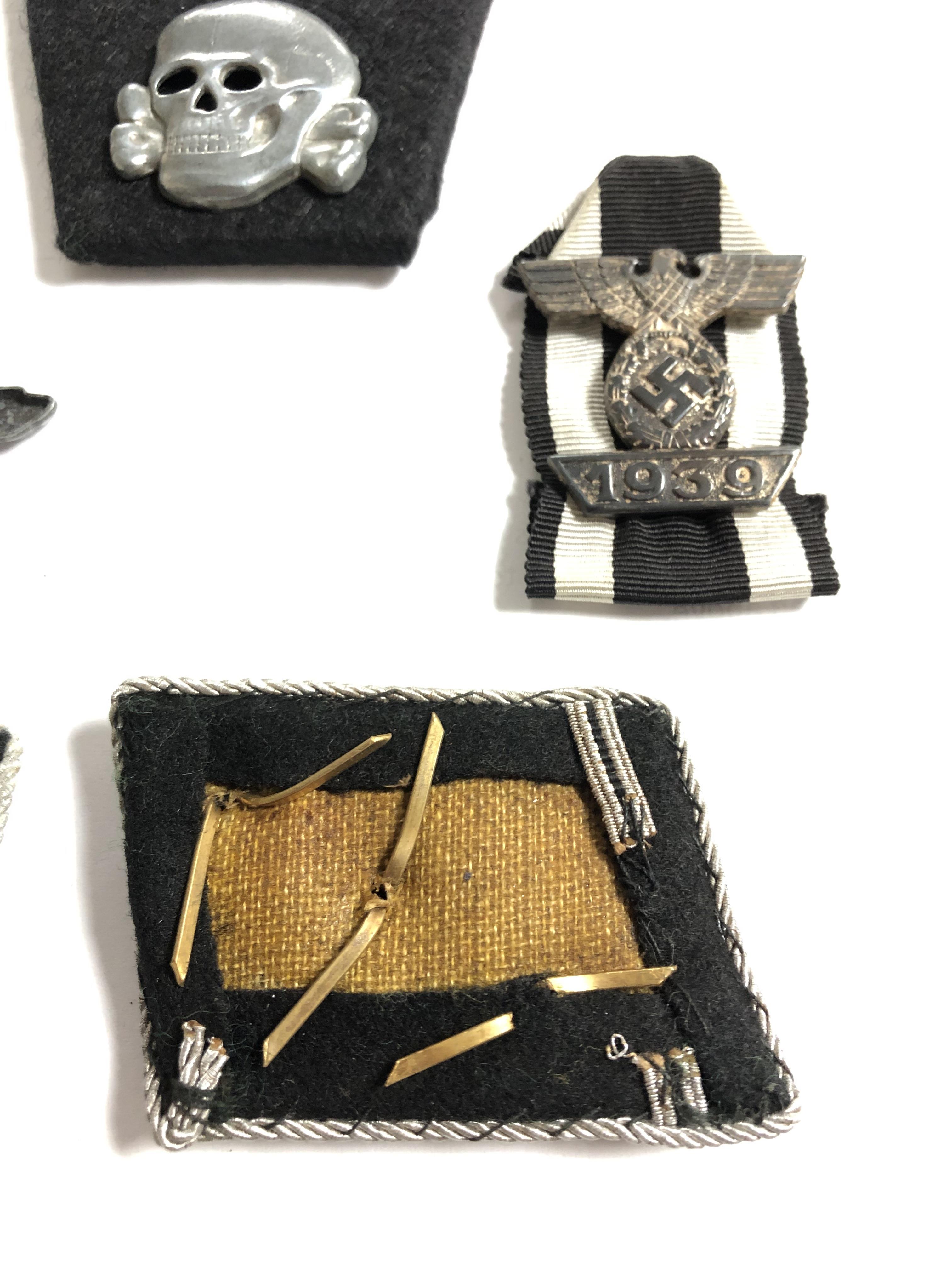 A group of German insignia including two Totenkopf skull cap badges, two eagle cap badges, - Image 3 of 8