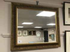 A gilt framed mirror 'Rolex', inscribed verso 'Goldsmiths Notts',