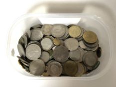 A plastic tub containing a quantity of British pre decimal coins and European coins