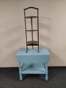 A painted drop leaf serving trolley on casters together with a three tier cake stand