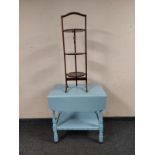 A painted drop leaf serving trolley on casters together with a three tier cake stand