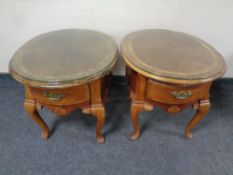A pair of French style oval end tables fitted a drawer