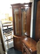 A reproduction glazed bow fronted corner cabinet