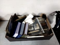 A box containing old postcards, three albums of shipping postcards and photographs,