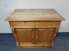 A Victorian carved pine side cabinet fitted cupboards and drawers beneath,