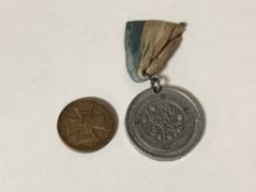 A World War I German token and a WWI Armistice medal