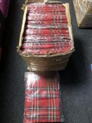 A box containing a large quantity of tartan scarves