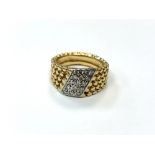 An 18ct gold textured, diamond set ring, size M. CONDITION REPORT: 9.