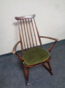An Ercol solid elm and beech rocking chair in an antique finish