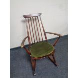 An Ercol solid elm and beech rocking chair in an antique finish