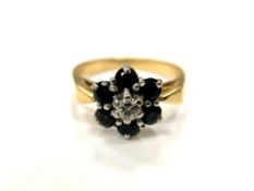 An 18ct gold sapphire and diamond cluster ring, size N.