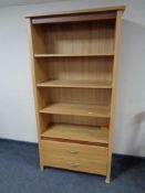 A contemporary oak open bookcase fitted two drawers with adjustable shelves,