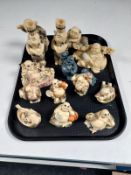 A tray containing approximately sixteen oriental resin figures,