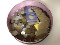 A circular box containing British and continental coins,