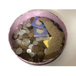 A circular box containing British and continental coins,
