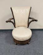 An Art Deco oak bedroom chair in cream upholstery