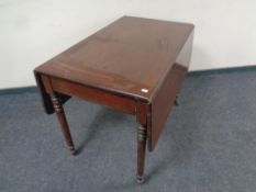 A 19th century mahogany drop leaf table fitted a drawer on casters CONDITION REPORT: