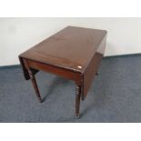 A 19th century mahogany drop leaf table fitted a drawer on casters CONDITION REPORT: