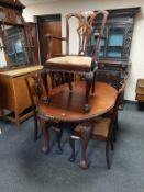 A mahogany extending oval dining table on claw and ball feet, length 150 cm,