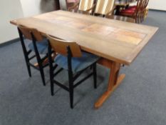 A mid 20th century teak refectory dining table with a tiled inset panel together with a set of four