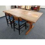 A mid 20th century teak refectory dining table with a tiled inset panel together with a set of four