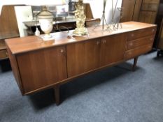 A Younger teak low sideboard fitted cupboards and drawers,