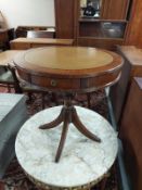 A reproduction mahogany drum table with leather inset panel